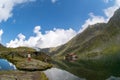 Balea lake and Balea Hotel in spring time with clouds Royalty Free Stock Photo